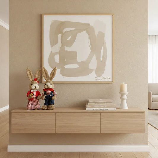 Enfeite de páscoa coelhos de palha em aparador moderno com quadro abstrato.