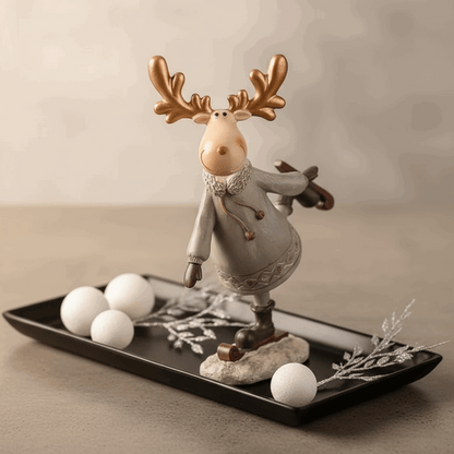 estatueta rena patinadora em resina sobre bandeja decorativa